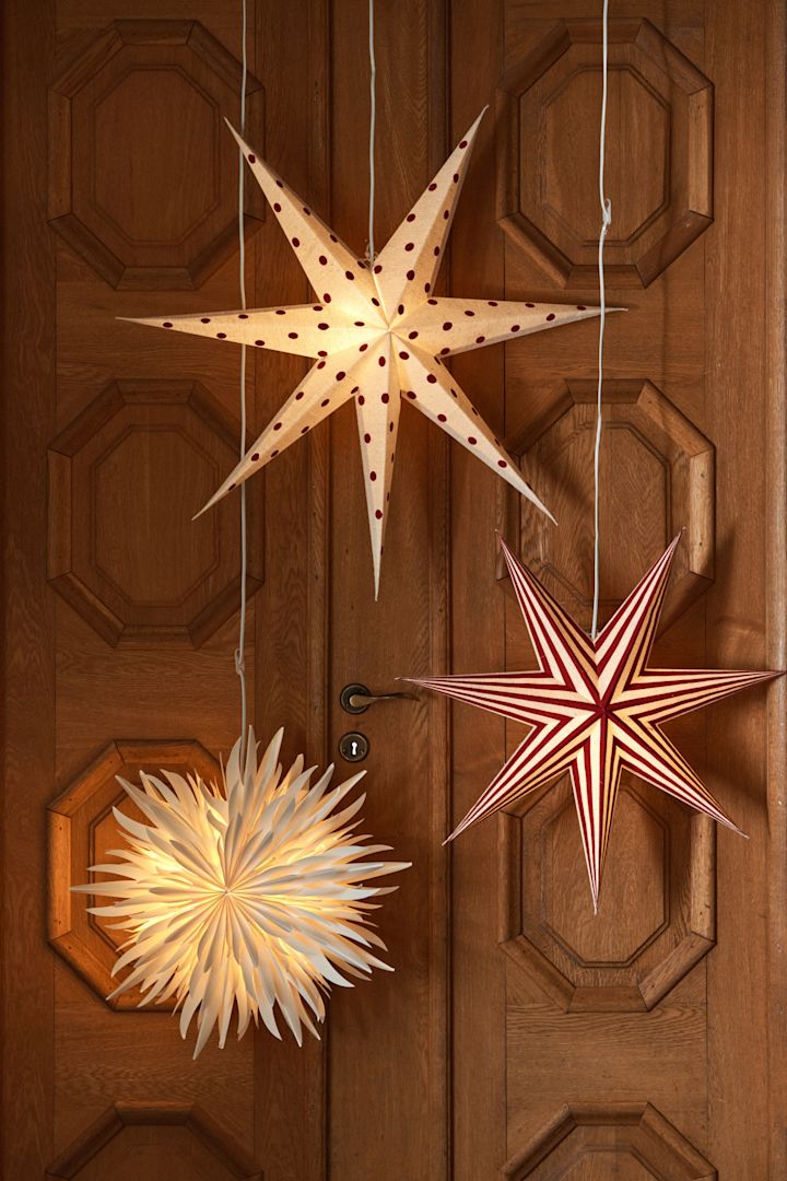 Paper star lanterns with red and white stripes and red polka dots and intricate paper designs from Scandi Living. 